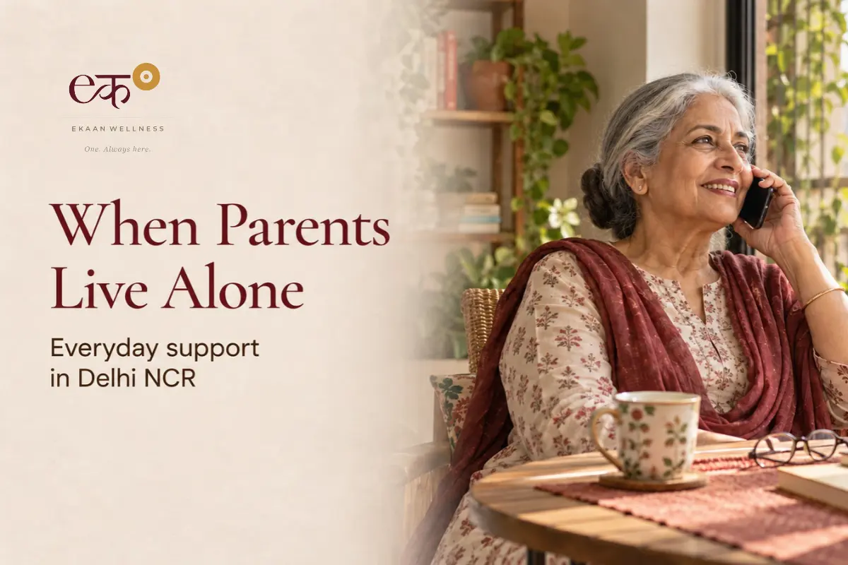 An elderly woman smiling while talking on the phone with family from her home in Delhi NCR